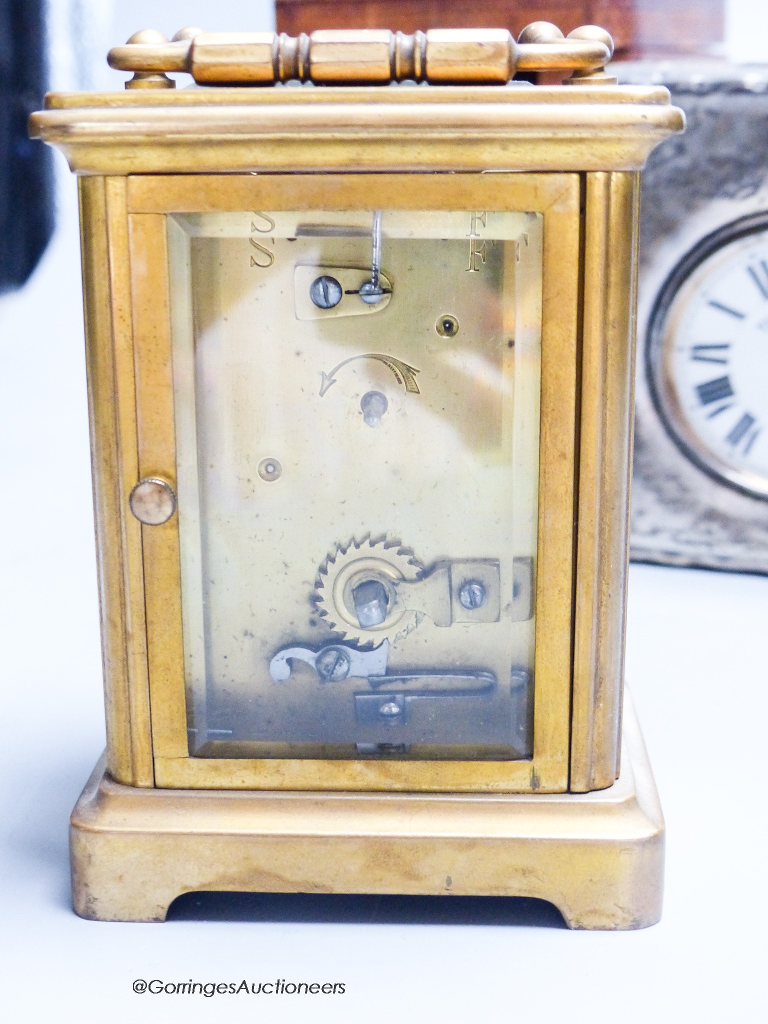 A cased carriage clock and a silver mounted motorwatch